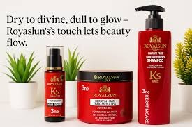 A 3-piece hair care set from Royalsun in vibrant red packaging. The set includes a tall Sulfate-Free Shampoo bottle with a pump, a wide jar of Keratin Hair Treatment Spa with Jojoba Oil, and a small pump bottle of Hair Serum. The background includes small potted green plants.